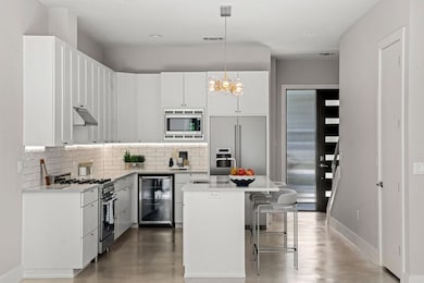 Kitchen with hanging light fixtures, backsplash, 