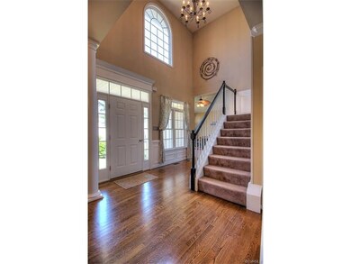 Beautiful and open foyer with columns, hardwood fl