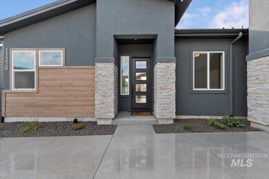 Entrance to property with stucco siding and stone siding