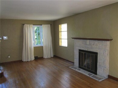 Living room with hardwood floors and gas fireplace