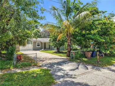 View of front of property with driveway, stucco siding, and a porch