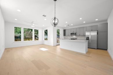 Kitchen featuring light wood-style floors, gray c