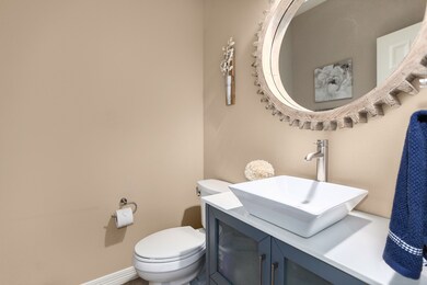 A quaint powder bath with vessel sink and cabinet for storage!
