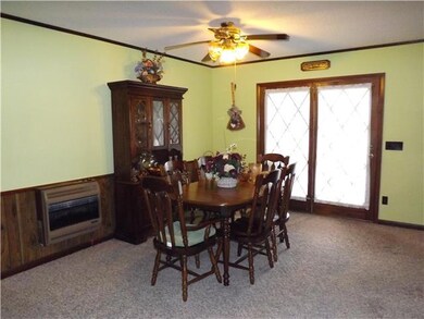 The dining room is attached to the kitchen and is open to the living room as well.  It also has French doors leading to the screened in porch.