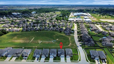 An aerial view of a spacious subdivision lot, highlighting a well-maintained yard and a fully fenced perimeter, offering both privacy and expansive outdoor space.