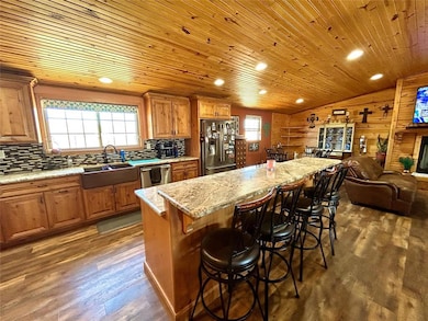 Kitchen with dark wood-style floors, plenty of nat