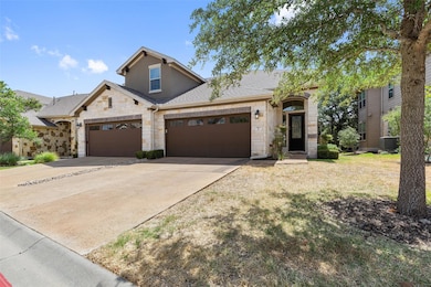 View of front of house featuring stone siding, concrete driveway, a shingled roof, an attached garage, and a front lawn
