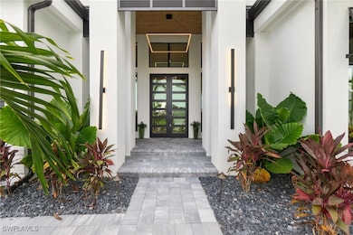 Doorway to property with french doors and stucco s