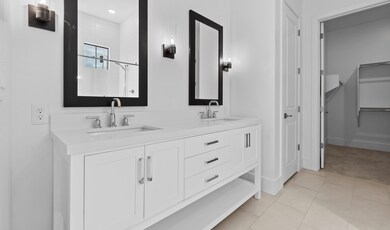 Primary bath features freestanding vanity with dual sinks