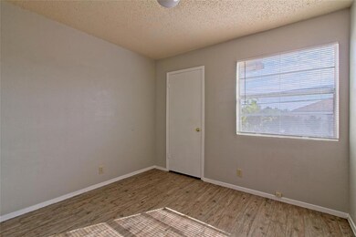 Spare room with baseboards, wood finished floors,