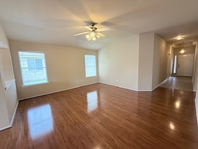 Spare room featuring wood finished floors and a ce