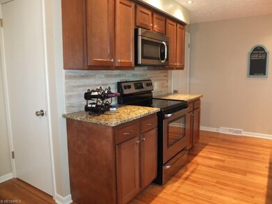 Kitchen has tile backsplash, a pantry and stainles