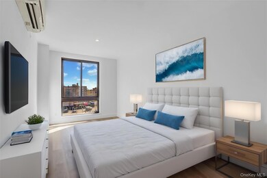 Bedroom featuring an AC wall unit, wood finished floors, and recessed lighting