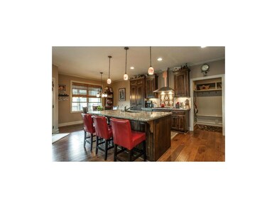 Chef's dream kitchen with a large gas stove, hood,