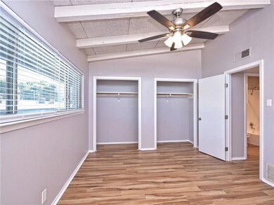 Unfurnished bedroom featuring vaulted ceiling wit