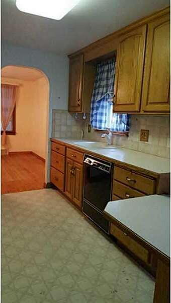 Kitchen Lots of oak cabinets and tile backsplash