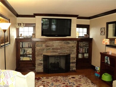 Living room with fireplace and built-in cabinets.