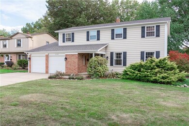 View of front of home with a front lawn and a gara