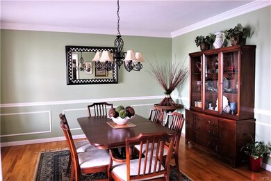 Lovely dining room with beautiful hardwoods and crown molding.