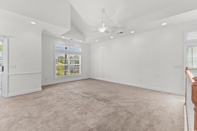 Carpeted empty room featuring ceiling fan, high va