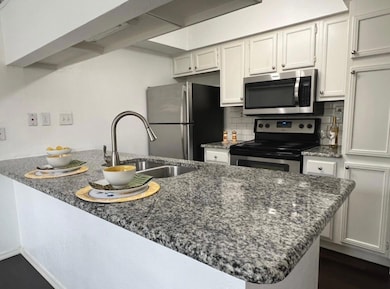 Kitchen featuring decorative backsplash, a sink, d