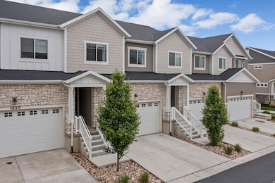 View of front facade featuring stone siding, a residential view, driveway, board and batten siding, and an attached garage