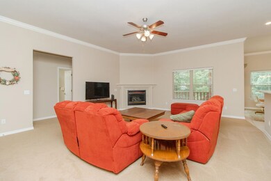 This Living Room features a corner gas log fireplace and 10' ceilings