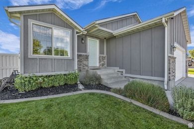 Property entrance featuring board and batten siding and an attached garage