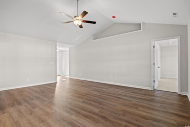 Unfurnished living room featuring a ceiling fan, h