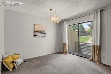 living room with new paint, a chandelier and carpet