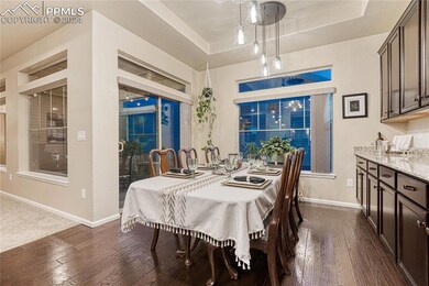 The dining area has lots of natural light, wood fl