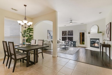 Dining space with a glass covered fireplace, ligh