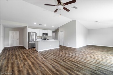Unfurnished living room featuring ceiling fan, dar
