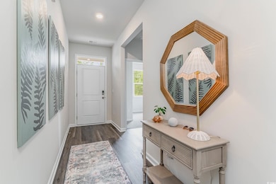 Entryway featuring wood finished floors and baseboards
