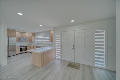 Kitchen featuring light brown cabinets, light coun