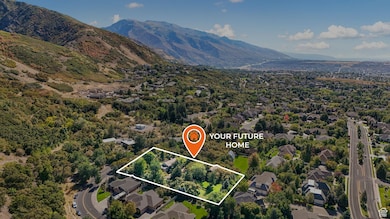 Aerial perspective of suburban area featuring a mountain backdrop and property parcel outlined