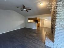 Unfurnished living room featuring vaulted ceiling
