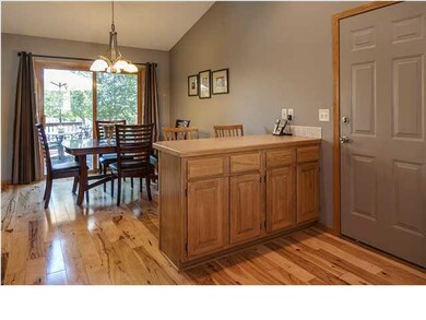 Kitchen and dining room have gleaming hickory floo
