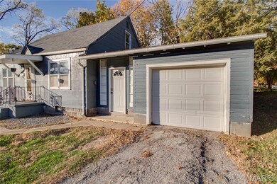 View of front of house featuring roof with shingles, driveway, and an attached garage