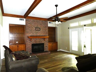 Living room with ceiling fan, beam ceiling, dark w