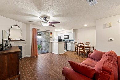 Living area with visible vents, a ceiling fan, a 