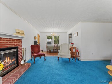 Living area with a chandelier, carpet flooring, a
