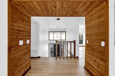 Corridor with wooden walls, visible vents, wooden