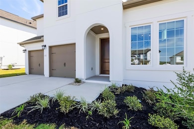 View of front of home with stucco siding, driveway, and an attached garage