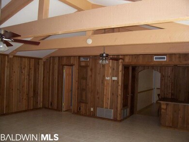 The Den/Family room is 570 sq ft. Porceline ceramic tile highlight the room. Easy to maintain. Note the massive Cedar beams.