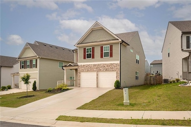 Craftsman house with an attached garage, stone siding, driveway, and cooling unit