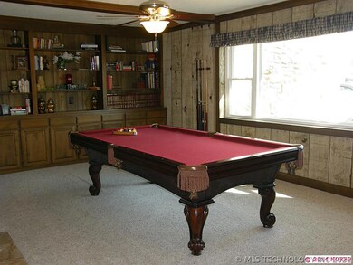 Game Room with Bookshelves and Fireplace