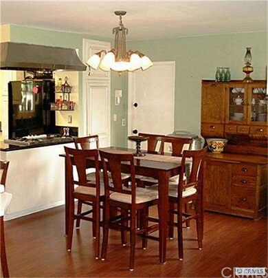 Formal dining area adjacent to kitchen.  Room for 