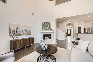 Living area with wood-type flooring, a towering c