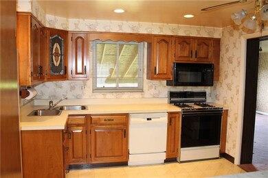 Kitchen with updated wood cabinetry, dishwasher, g